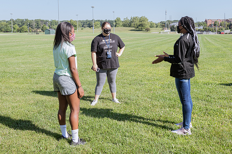 Freshmen Taylor Baker (left) and Emma Davis (middle) talk to Ruth Bambo, a peer mentor and senior in the College of Science, during a break in activities for the Emerging Leaders Science Scholars program. (Purdue University photo/Rebecca McElhoe)