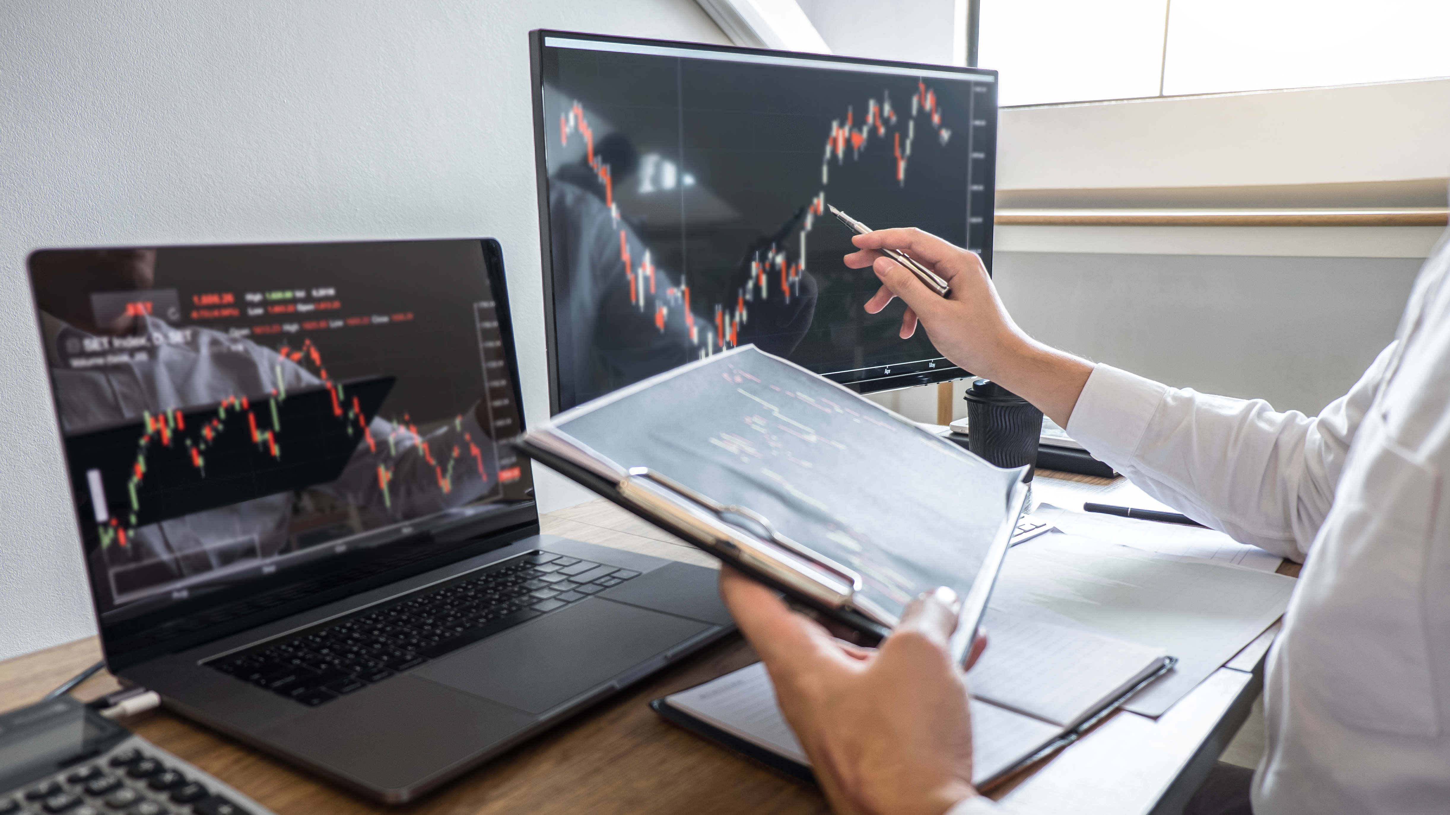 Person sitting in front of having a planning and analyzing with display screen and pointing on the data. (Adobe Stock)