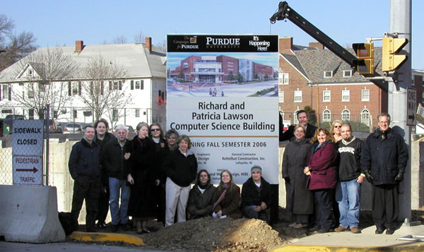 CS faculty and staff in front of sign