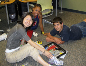 Middle school students construct lego robots at CS camp. 