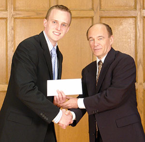 Prof. Buster Dunsmore congratulates Jonathan Micklos