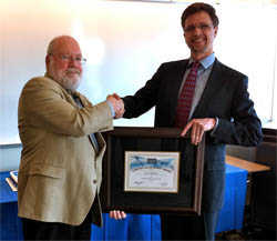 Prof. Eugene Spafford accepting a Lifetime Achievement Award from Lance Spitzner of SANS. 