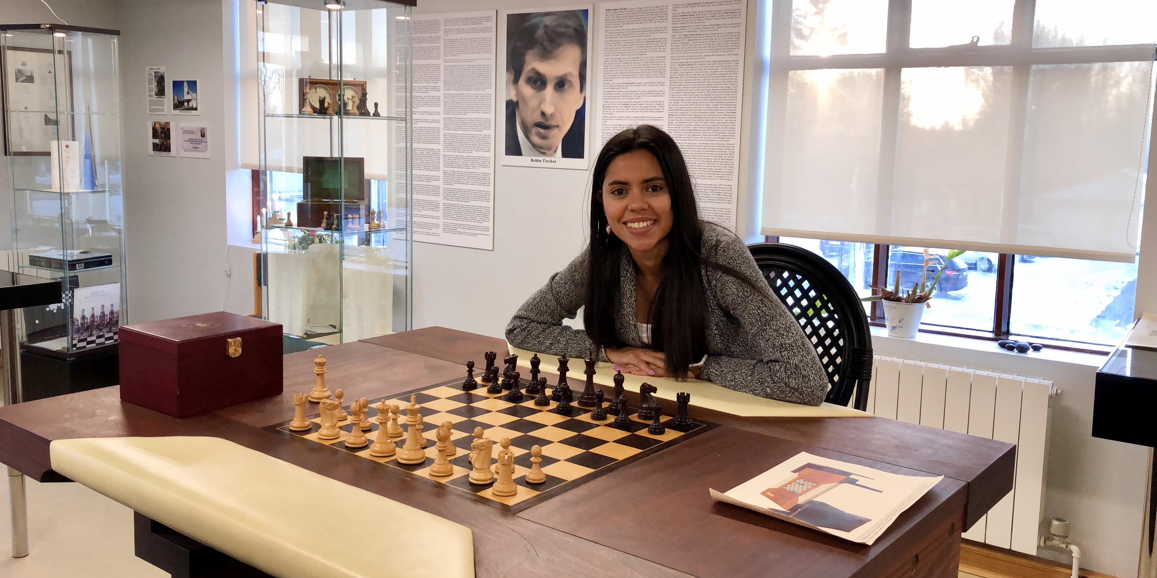 Nadya Ortiz, (MS in CS, 2014) poses behind a chess board.