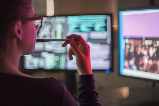 security professional working on a screen, evaluating risk