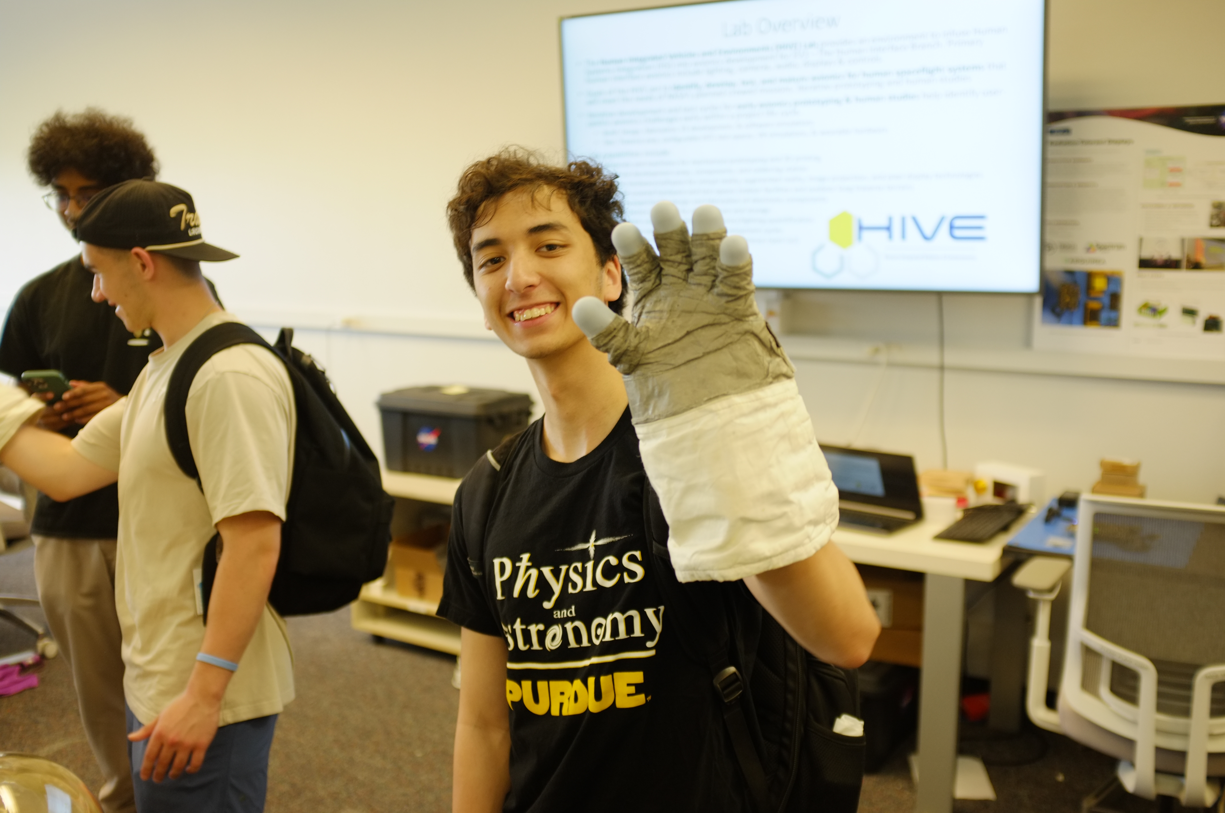 From left to right: Anand Shanker, Zach O’Connell, and Paul Greenberg play around with spacesuit haptics at NASA’s HIVE Laboratory.