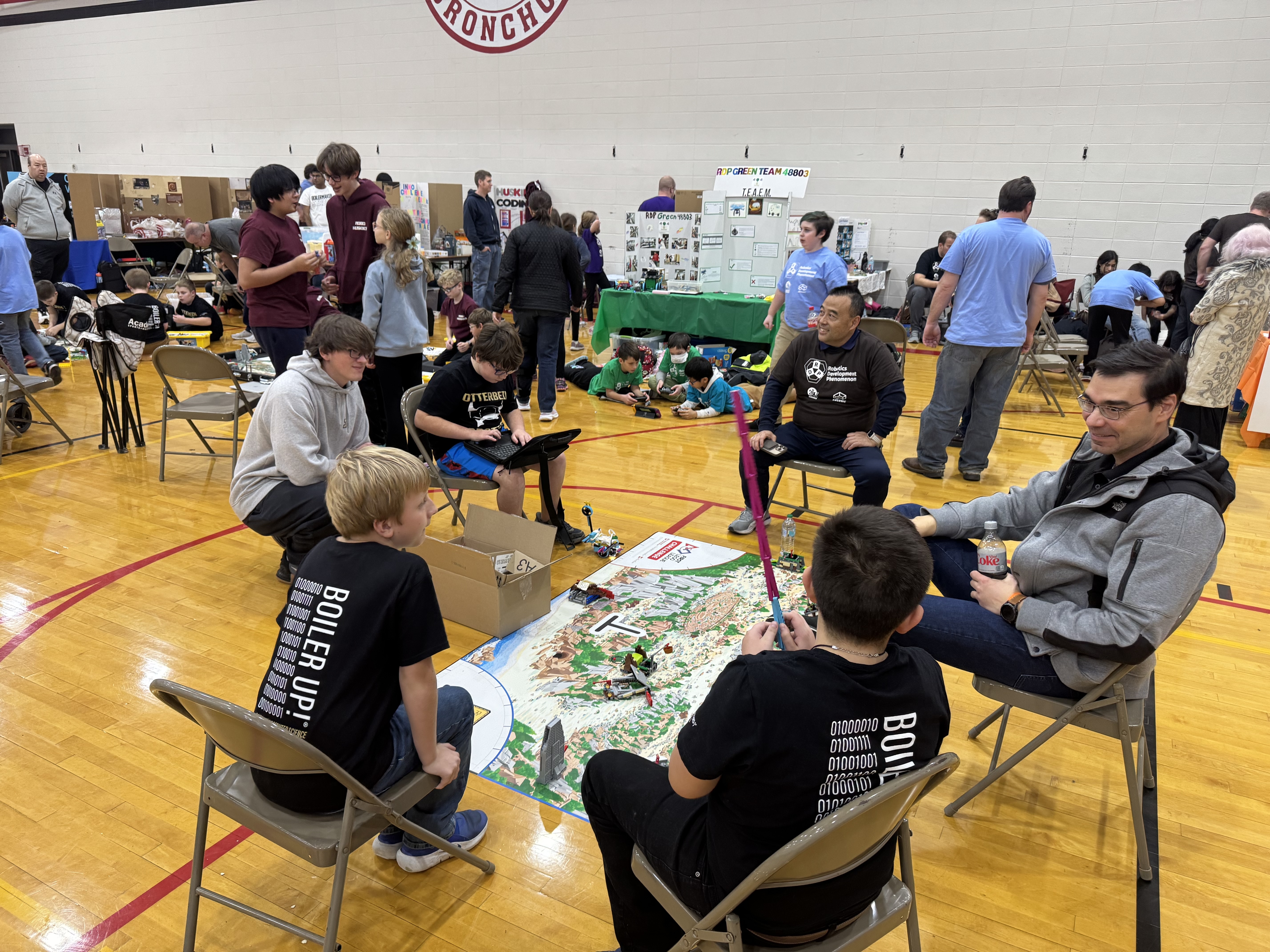 students working on robots and talking with faculty